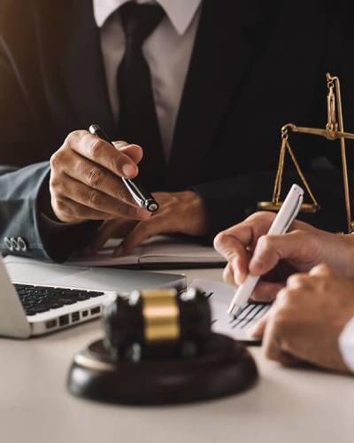 Attorney meeting with client as they sign documents