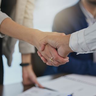 shaking hands and thank you handshake of a corporate worker in a office.