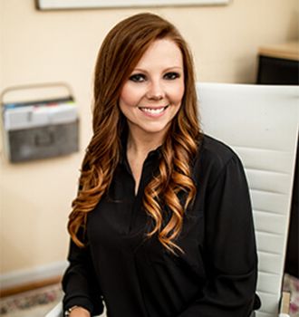 Kayla sitting at her desk