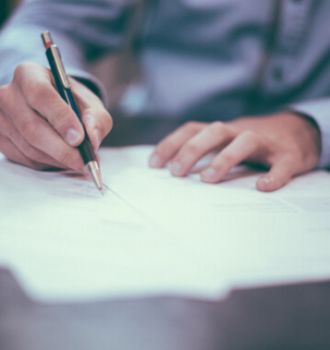 Man Writing on Paper
