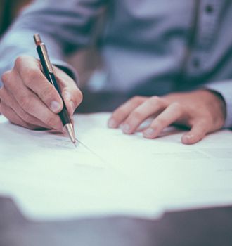 man signing documents