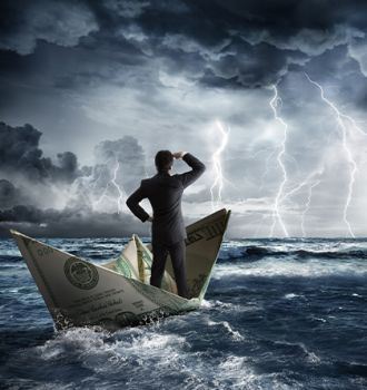 Person in suit on boat made from dollar bill