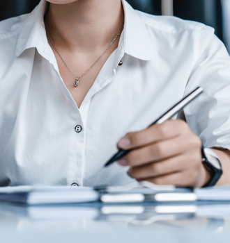 A business woman taking notes at her desk