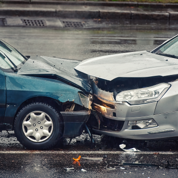 Car wreck while it is raining on a highway.