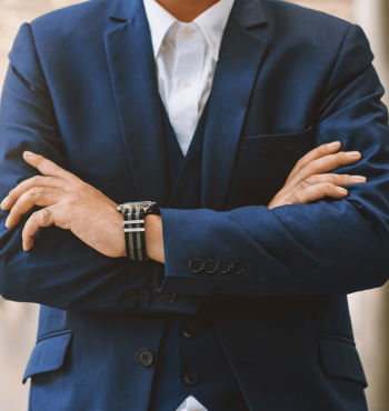 Close up young businessman holding arms folded.