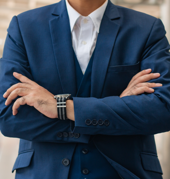 young businessman holding arms folded.