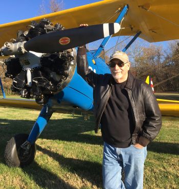 William "Bill" G. Harger standing next to a plane.