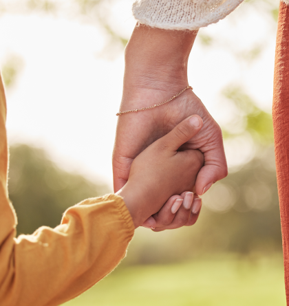A woman holding her daughter's hand