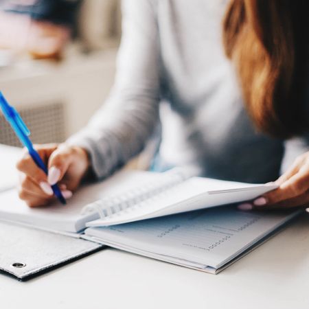 Woman writing in planner