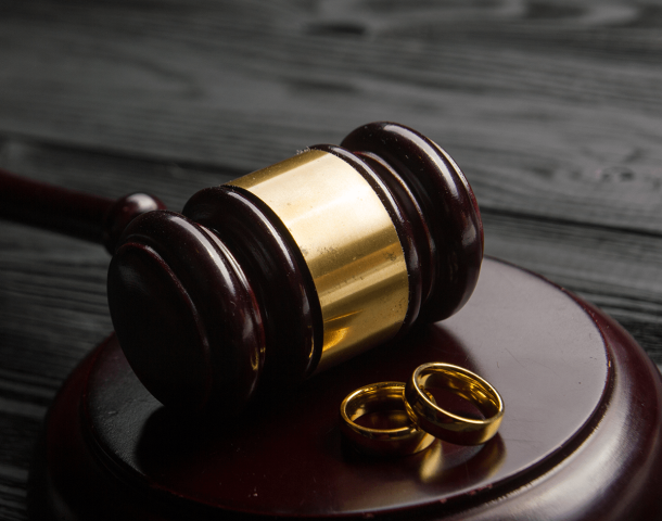 Two golden wedding rings, judge gavel.