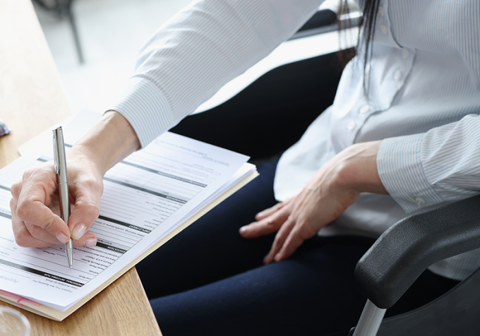 Disabled woman in wheelchair filling out application for employment