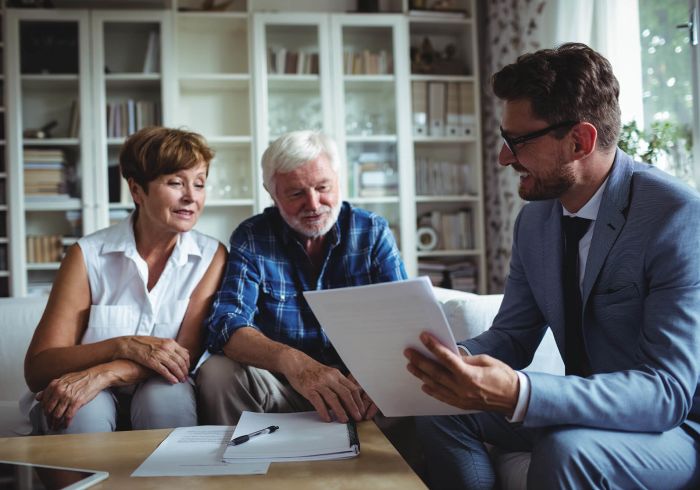 Senior couple planning their investments with financial advisor