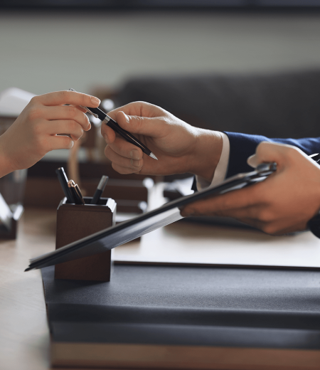 Male lawyer working with clients in office.