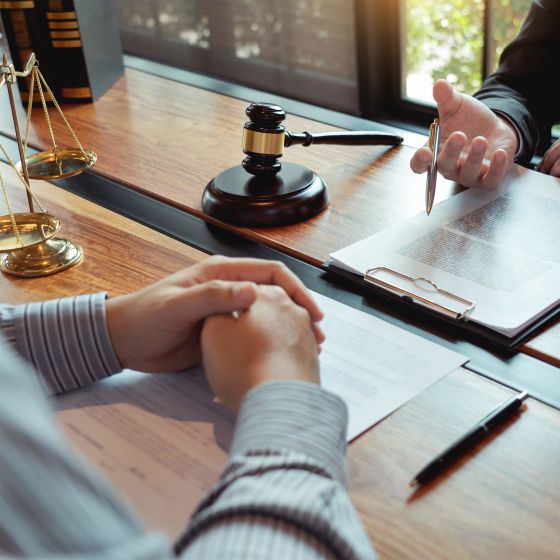 Lawyer working with client discussing contract papers