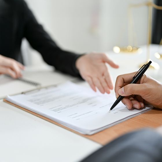 An attorney having her client sign documents