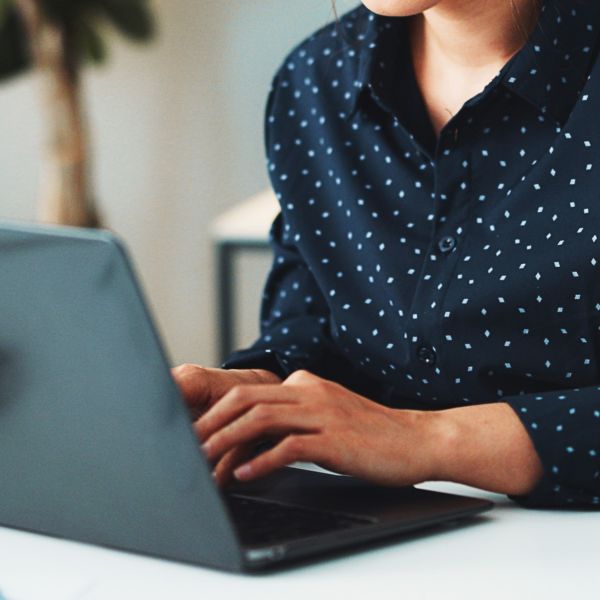 A woman typing on her laptop