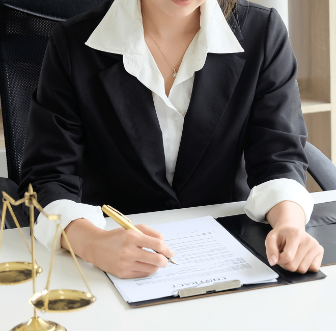 Asian young woman lawyer who is currently working on financial information reading a contract on paper document in private office.