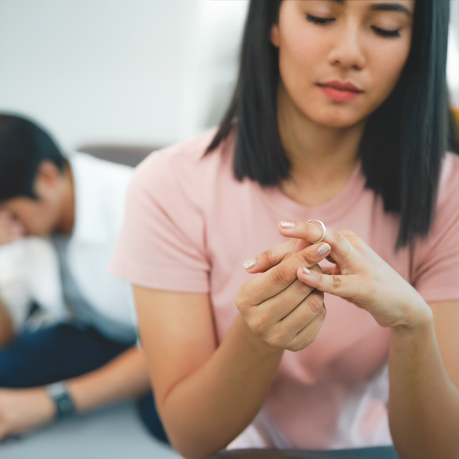 A woman removing her wedding ring