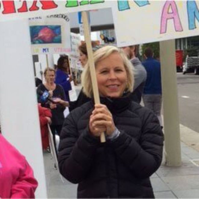 Holly Ennis holding a sign