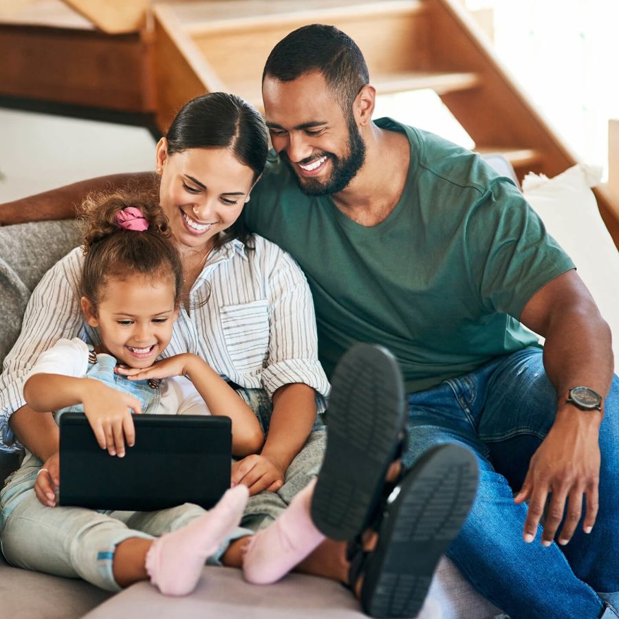 Happy family looking at tablet together