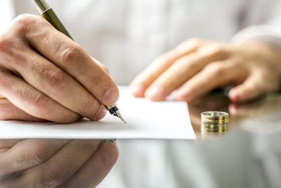 Wedding ring with person signing documents