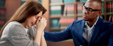 An attorney comforting his client