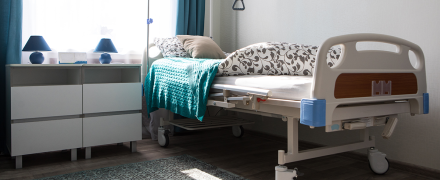 A nursing home bed in a room.