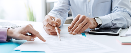 Two people going over a document together.