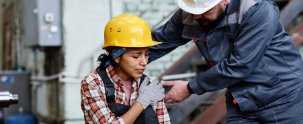 An injured worker getting help from someone.
