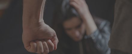 Woman abuse, Young woman scared, male clenched fist close up.