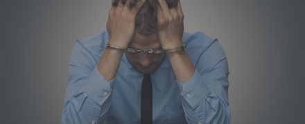 desperate businessman with handcuffs