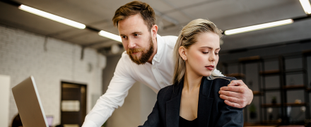 A coworker inappropriately touching his female coworker.