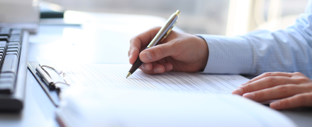 A man writing on a document.