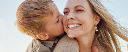 A son kissing her mom.