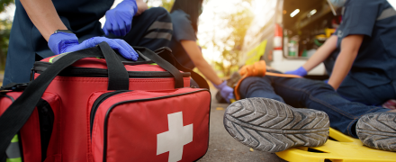 Someone lying down on a stretcher receiving medical attention.