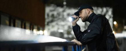 A security guard with his flashlight.