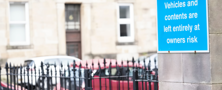 A liability sign in a parking lot.