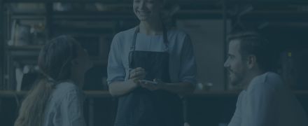 Smiling waitress hold notepad take order serving couple customers