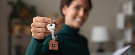 A woman holding property keys