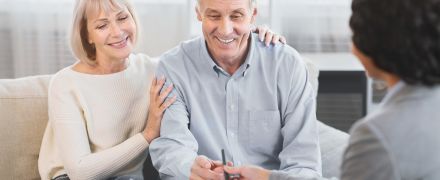 An older couple signing estate planning documents