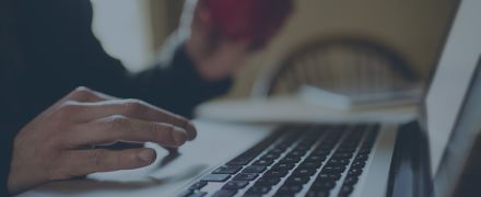 Cropped image of person using laptop