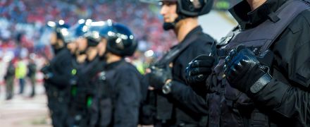 A line of police officers at a riot.