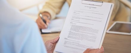 A woman looking over her will.