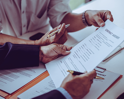 Group of middle age Asian business people and lawyers discussing and sign a contract.