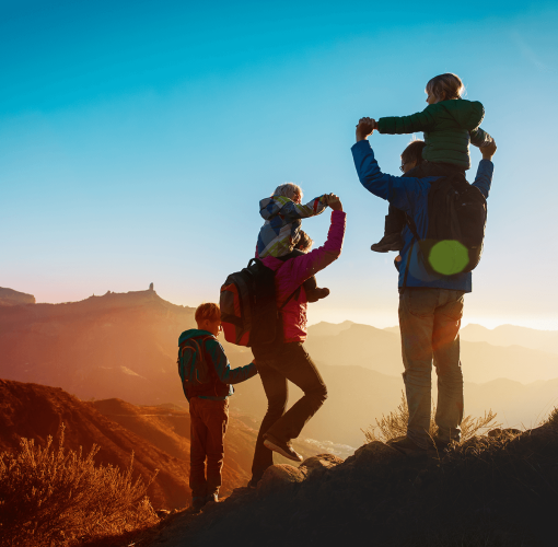 Family hiking through the mountains at sunset
