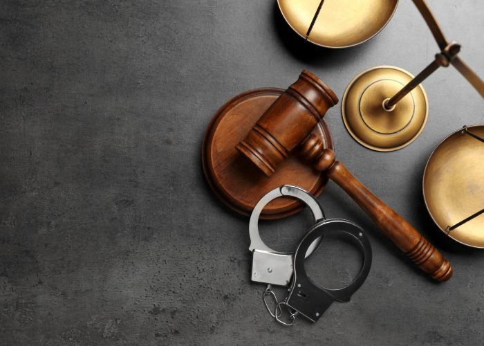 gavel with handcuffs on table