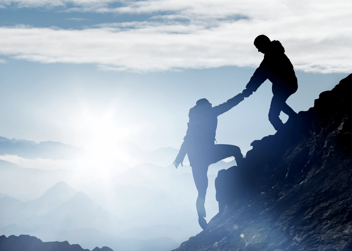 Mountaineers help each other to reach the summit