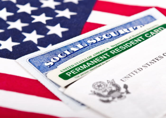 An United States flag, social security card and permanent resident card