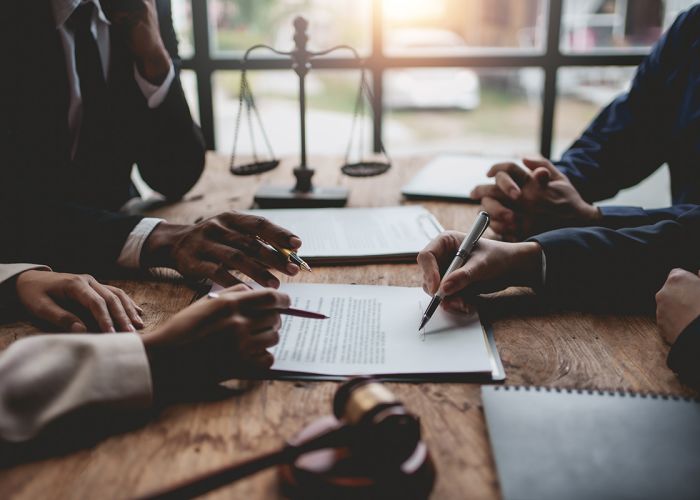 A legal team gathered around a contract.