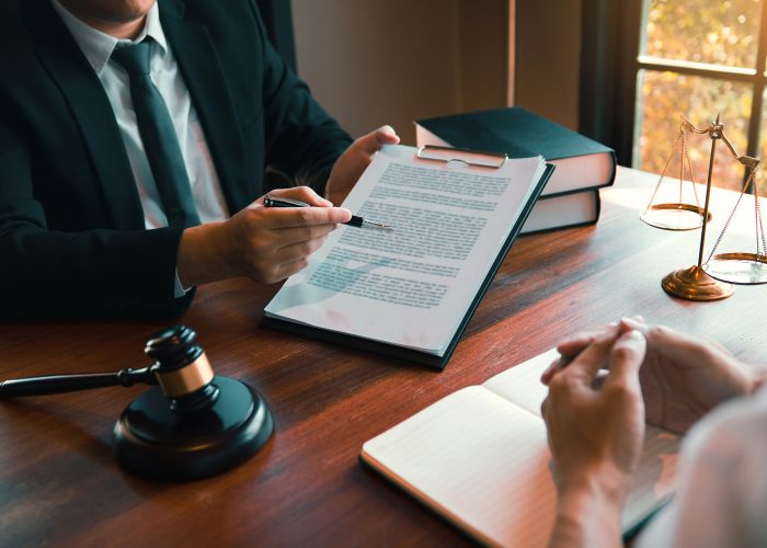 Group of middle age Asian business people and lawyers discussing and sign a contract.